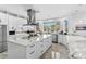 Modern kitchen with sleek white cabinets, a large island, and stainless steel appliances at 3700 Waterford Dr., Myrtle Beach, SC 29577
