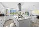 Spacious kitchen features white cabinetry, marble countertops and large island with views overlooking the manicured backyard at 3700 Waterford Dr., Myrtle Beach, SC 29577