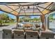 Outdoor dining area in gazebo with a dining table set for a meal, overlooking the pool at 3700 Waterford Dr., Myrtle Beach, SC 29577