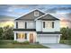 Charming two-story home with a covered porch, attached garage, and beautifully landscaped front yard at 397 Wingspan Ct., Myrtle Beach, SC 29588