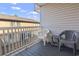 Outdoor balcony seating area with bright sky and outdoor neighborhood views at 401 Hillside Dr. N # 2F, North Myrtle Beach, SC 29582