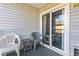 Private balcony seating area with sliding glass door access to indoor room at 401 Hillside Dr. N # 2F, North Myrtle Beach, SC 29582