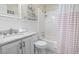 Neat bathroom featuring a sink vanity and a shower with white and peach colored curtain at 401 Hillside Dr. N # 2F, North Myrtle Beach, SC 29582