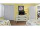 Bright bedroom featuring a white dresser, television, and nautical-themed decor at 401 Hillside Dr. N # 2F, North Myrtle Beach, SC 29582