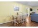 Cozy dining area with seating for four, adjacent to the living room at 401 Hillside Dr. N # 2F, North Myrtle Beach, SC 29582