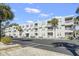 Low angle of condominium building with parking, palm trees, and a blue sky at 401 Hillside Dr. N # 2F, North Myrtle Beach, SC 29582