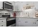 Modern kitchen with white cabinets, stainless steel appliances, and a decorative backsplash at 401 Hillside Dr. N # 2F, North Myrtle Beach, SC 29582