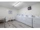 Community laundry room with multiple washing machines and dryers for resident use at 401 Hillside Dr. N # 2F, North Myrtle Beach, SC 29582