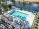Aerial view of community pool area with a clear pool, shed, and pond at 401 Hillside Dr. N # 2F, North Myrtle Beach, SC 29582
