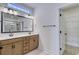 Bathroom with double vanity, sleek fixtures, and a view into a walk-in closet at 4028 Bucolic Loop, Myrtle Beach, SC 29588