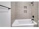 Stylish bathroom showcasing tiled shower, built-in niche, and modern black fixtures at 4028 Bucolic Loop, Myrtle Beach, SC 29588