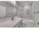 Clean bathroom featuring a tub and shower combo, sleek white vanity, and neutral tile at 4028 Bucolic Loop, Myrtle Beach, SC 29588