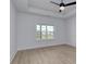 Neutral Primary bedroom with tray ceiling and large window overlooking the backyard at 4028 Bucolic Loop, Myrtle Beach, SC 29588