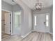 Bright foyer with light wood flooring, a modern light fixture, and access to other rooms at 4028 Bucolic Loop, Myrtle Beach, SC 29588