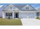 Charming two-story home with a two car garage, landscaped yard, and welcoming front porch at 4028 Bucolic Loop, Myrtle Beach, SC 29588
