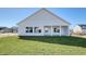 Rear exterior view of home featuring a covered patio and large windows at 4028 Bucolic Loop, Myrtle Beach, SC 29588