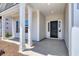 Inviting front porch with stylish columns and a sleek black front door at 4028 Bucolic Loop, Myrtle Beach, SC 29588