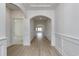 Bright hallway features stylish arches and light wood flooring leading into the living spaces at 4028 Bucolic Loop, Myrtle Beach, SC 29588