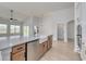 Bright kitchen with a large island, stainless steel appliances, and a view of the backyard at 4028 Bucolic Loop, Myrtle Beach, SC 29588