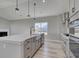 Spacious kitchen island with sink, modern faucet, and sleek countertops, open to living area at 4028 Bucolic Loop, Myrtle Beach, SC 29588