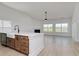 Kitchen island boasts wood cabinets, white countertops, & sink at 4028 Bucolic Loop, Myrtle Beach, SC 29588