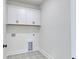 Clean, dedicated laundry room with cabinets and modern patterned flooring at 4028 Bucolic Loop, Myrtle Beach, SC 29588