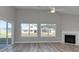 Bright living room features hardwood floors, fireplace, and large windows at 4028 Bucolic Loop, Myrtle Beach, SC 29588
