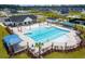 Community pool featuring a beach entry, lounge chairs, and umbrellas at 4028 Bucolic Loop, Myrtle Beach, SC 29588
