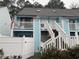 Charming two-story exterior with light blue wood paneling, white railings, and staircase at 405 Cambridge Circle # B5, Murrells Inlet, SC 29576