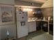 Cozy kitchen featuring wood-paneled walls, white appliances, and a vintage aesthetic at 405 Cambridge Circle # B5, Murrells Inlet, SC 29576
