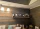 Close-up of a kitchen shelf showcasing decorative items and natural wood paneling at 405 Cambridge Circle # B5, Murrells Inlet, SC 29576