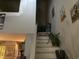 A white staircase with decorative plants, complemented by various framed art pieces at 405 Cambridge Circle # B5, Murrells Inlet, SC 29576