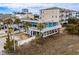 Exterior aerial view of a charming coastal home, surrounded by palms and marshland landscape at 409 25Th Ave. N, North Myrtle Beach, SC 29582