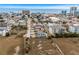 An aerial view shows a quaint blue house near the ocean and city buildings at 409 25Th Ave. N, North Myrtle Beach, SC 29582