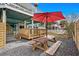 Inviting backyard space with a picnic table under a red umbrella, and a wooden deck for outdoor gatherings at 409 25Th Ave. N, North Myrtle Beach, SC 29582