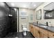 Modern bathroom featuring black marble, a glass shower, and wooden cabinets at 409 25Th Ave. N, North Myrtle Beach, SC 29582