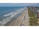 Breathtaking aerial showcases a sun-kissed beach, inviting turquoise waters, and stunning city skyline at 409 25Th Ave. N, North Myrtle Beach, SC 29582