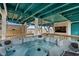 Relaxing hot tub area with a mounted TV and stylish wooden accents for ultimate outdoor entertainment at 409 25Th Ave. N, North Myrtle Beach, SC 29582