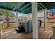 Covered deck featuring a modern hot tub with convenient steps, ideal for relaxation and entertainment at 409 25Th Ave. N, North Myrtle Beach, SC 29582