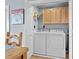 Convenient laundry area equipped with a washer, dryer, and storage cabinets at 409 25Th Ave. N, North Myrtle Beach, SC 29582