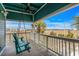 Relaxing porch with a swing offers serene views of the marshland and surrounding neighborhood at 409 25Th Ave. N, North Myrtle Beach, SC 29582
