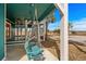 Charming porch swing hanging beneath a covered area, offering a cozy spot to relax outdoors at 409 25Th Ave. N, North Myrtle Beach, SC 29582