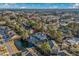 Scenic aerial view showcasing the community with a pond, mature trees, and clear skies at 4173 Hibiscus Dr. # 204, Little River, SC 29566