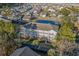 An aerial view of a multi-Gathering unit overlooking a pond with a dense neighborhood in the background at 4173 Hibiscus Dr. # 204, Little River, SC 29566