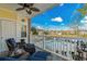 Inviting balcony featuring cozy seating with views of pool, landscaping, and clear skies at 4173 Hibiscus Dr. # 204, Little River, SC 29566