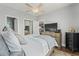 Cozy bedroom with neutral walls, ceiling fan, TV on dresser, and view of an open doorway at 4173 Hibiscus Dr. # 204, Little River, SC 29566