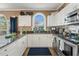 Well-lit kitchen featuring stainless steel appliances, granite countertops, white cabinets, and a decorative backsplash at 4173 Hibiscus Dr. # 204, Little River, SC 29566
