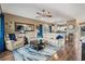 Open concept living room featuring hardwood floors, comfortable seating, a ceiling fan, and views of the kitchen at 4173 Hibiscus Dr. # 204, Little River, SC 29566