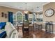 Living room and dining area featuring hardwood floors, comfortable seating, a ceiling fan, and views of the kitchen at 4173 Hibiscus Dr. # 204, Little River, SC 29566