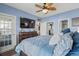 Well-lit main bedroom with a ceiling fan, flatscreen TV, and a door leading to the exterior at 4173 Hibiscus Dr. # 204, Little River, SC 29566